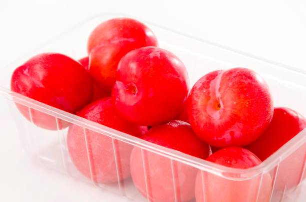 istock Punnet of fresh Japanese plum (Prunus salicina) on white background 1162232443