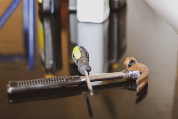 istock Close up image of a  screwdriver and a hammer in a workshop 1162233783