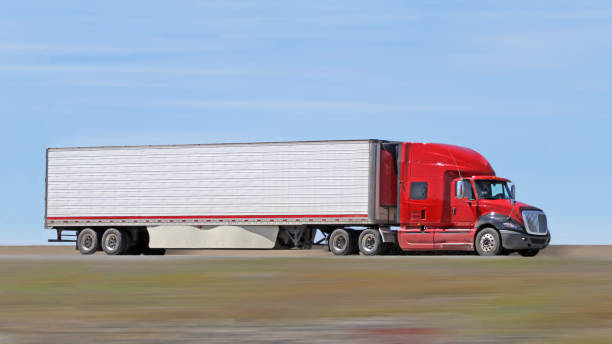 istock Semi Truck On Highway Delivering Its Load, Blurred Motion 1162239316