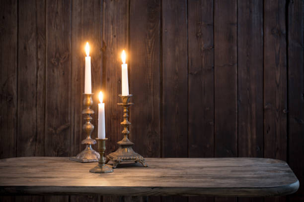 istock burning candle on old wooden background 1162241755