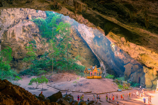 istock Buddhist temple in the cave with unidentifiable tourists around 1162241782