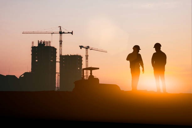 istock Silhouette of engineer and construction team working at site over blurred background for industry background with Light fair.Create from multiple reference images together 1162241848