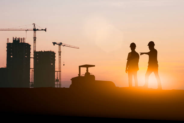 istock Silhouette of engineer and construction team working at site over blurred background for industry background with Light fair.Create from multiple reference images together 1162241849