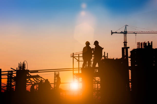 istock Silhouette of engineer and construction team working at site over blurred background for industry background with Light fair.Create from multiple reference images together 1162241852