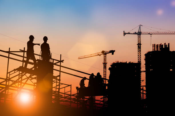 istock Silhouette of engineer and construction team working at site over blurred background for industry background with Light fair.Create from multiple reference images together 1162241853