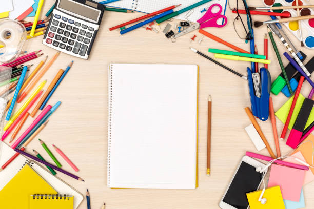 istock Workspace. Messed with stationery desk top view no people notebook and pencil 1162242005
