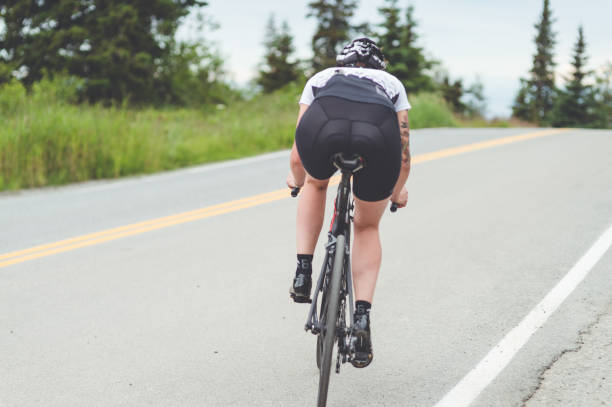 istock Cyclist rides along a rural highway 1162244651