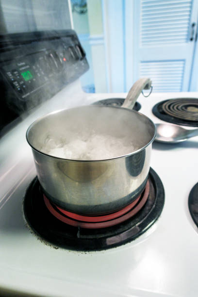 istock Eggs Cooking in Pot of Boiling Water on Kitchen Stove 1162247787