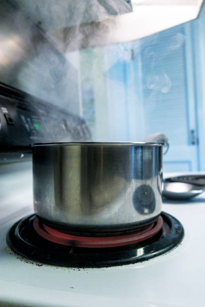 istock Steaming Heated Boiling Water in Saucepan on Electric Stove 1162247801
