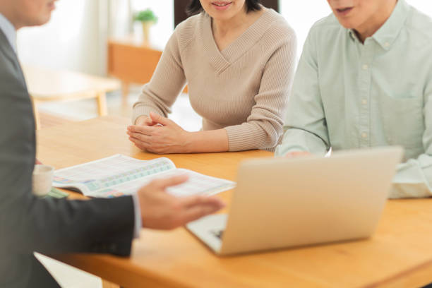 istock Businessman explaining to middle aged couple 1162248510