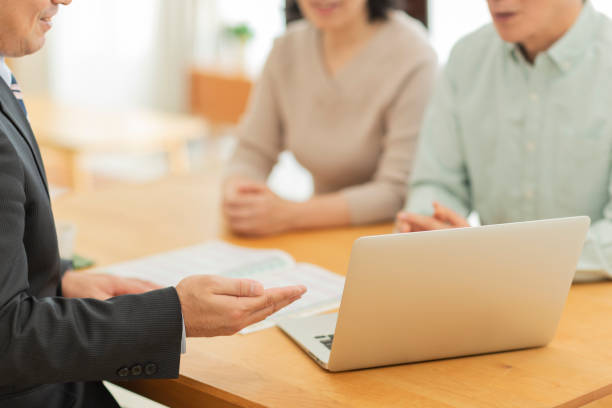 istock Businessman explaining to middle aged couple 1162248519