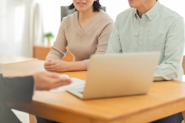 istock Businessman explaining to middle aged couple 1162248520