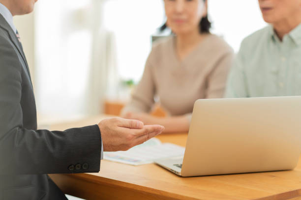 istock Businessman explaining to middle aged couple 1162248521