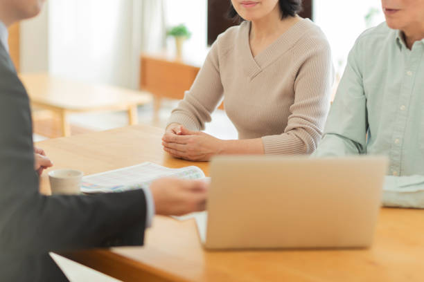istock Businessman explaining to middle aged couple 1162248523