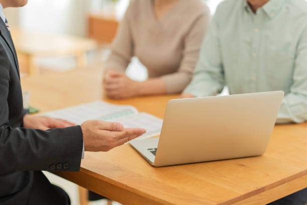istock Businessman explaining to middle aged couple 1162248524
