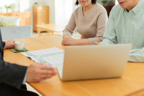 istock Businessman explaining to middle aged couple 1162248526
