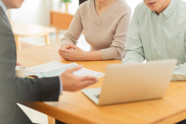 istock Businessman explaining to middle aged couple 1162248535