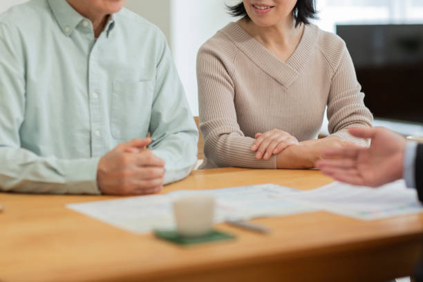 istock Businessman explaining to middle aged couple 1162248536