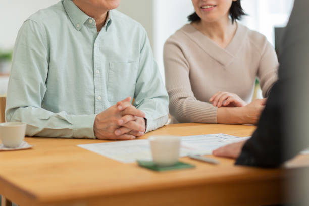 istock Businessman explaining to middle aged couple 1162248537
