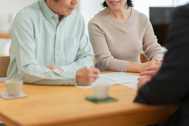 istock Businessman explaining to middle aged couple 1162248553