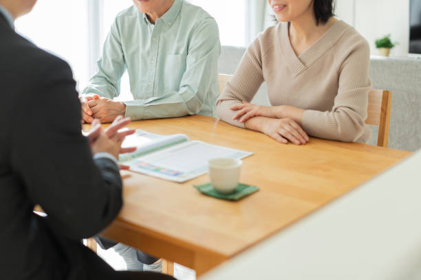 istock Businessman explaining to middle aged couple 1162248554