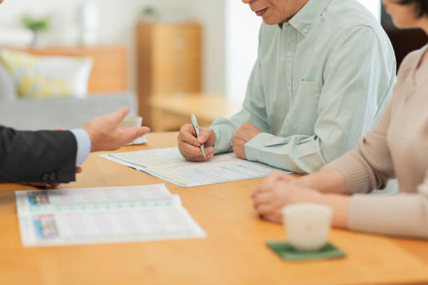 istock Businessman explaining to middle aged couple 1162248557