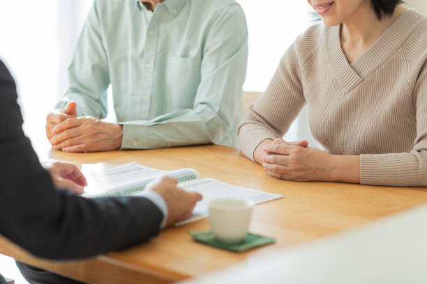 istock Businessman explaining to middle aged couple 1162248558