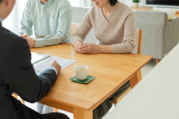 istock Businessman explaining to middle aged couple 1162248567