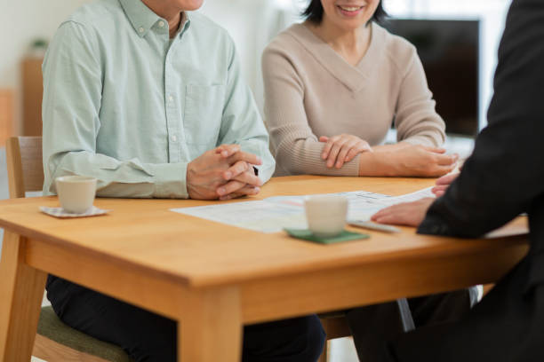 istock Businessman explaining to middle aged couple 1162248569