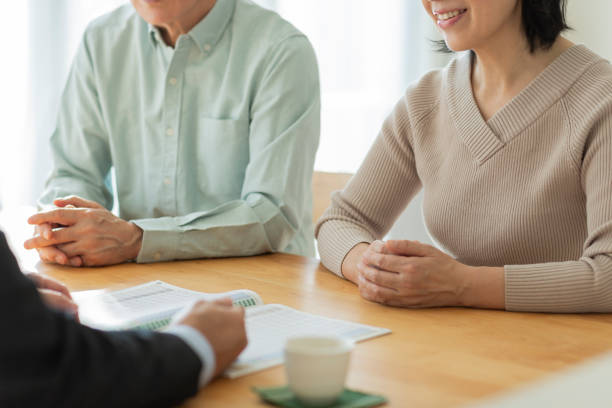 istock Businessman explaining to middle aged couple 1162248570
