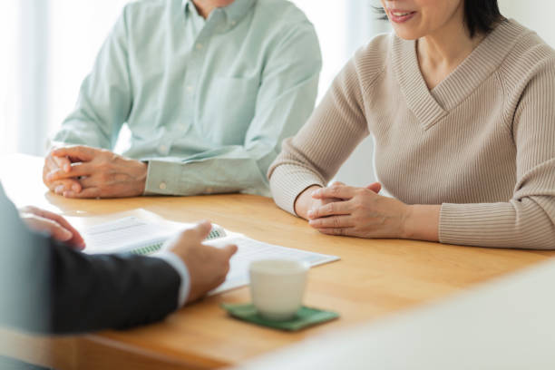 istock Businessman explaining to middle aged couple 1162248572
