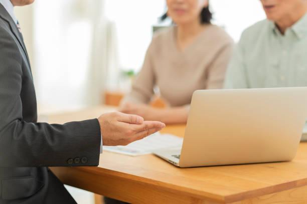 istock Businessman explaining to middle aged couple 1162250264