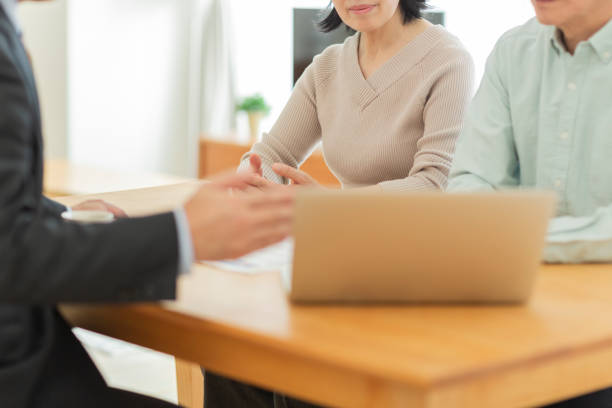 istock Businessman explaining to middle aged couple 1162250266
