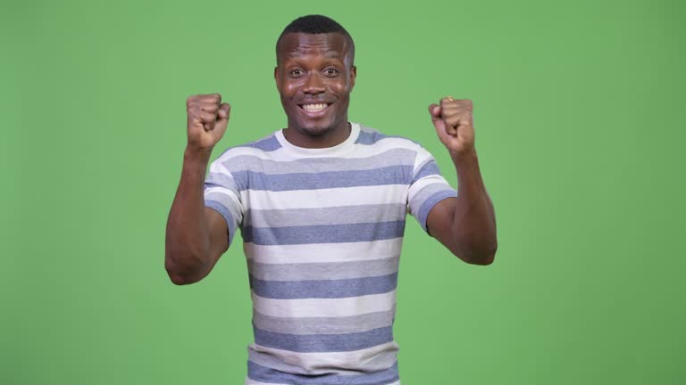 Happy young African man getting good news