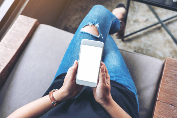 istock woman holding white mobile phone with blank screen 1162251640