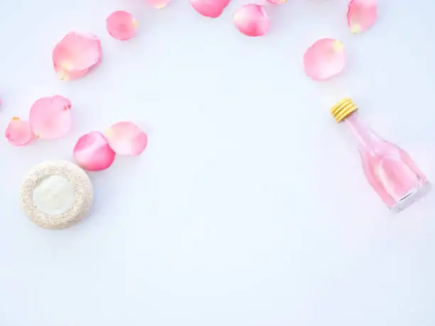 Natural cosmetic with rose oil and Scented candle potpourri on white background. top view, Space for text