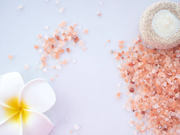 istock Pink salt in a spa set on white background / Himalayan salt 1162252442
