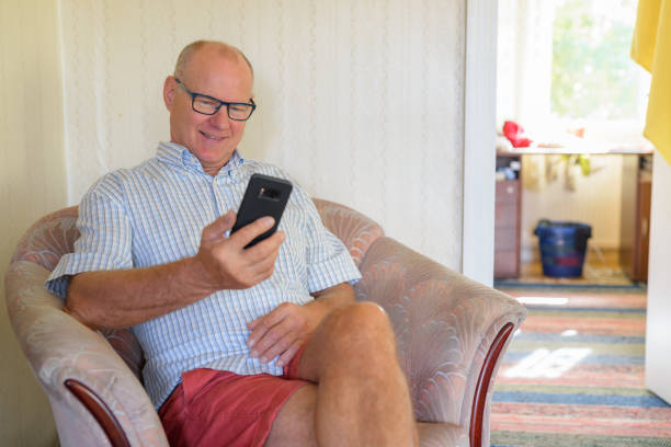istock Happy Senior Man Using Phone At Home 1162254887