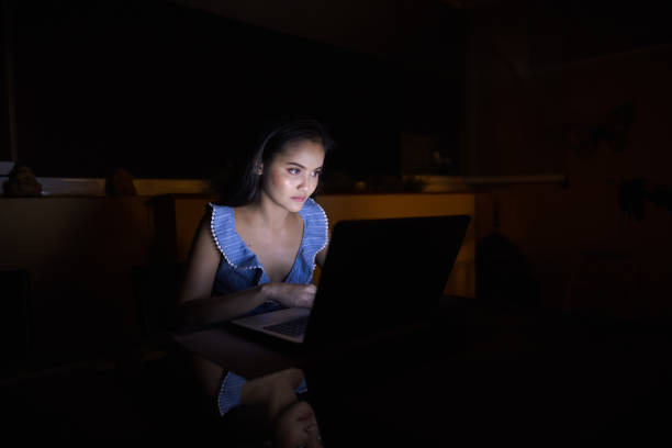 istock Young Asian Woman Using Laptop In Dark Room 1162255773