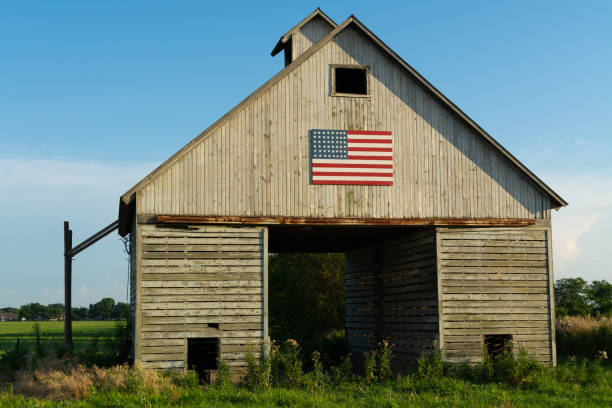 istock Old wooden barn with American Flag 1162255836