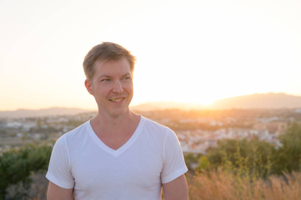 istock Young Handsome Tourist Man Smiling While Thinking On Top Of The Hill 1162255863
