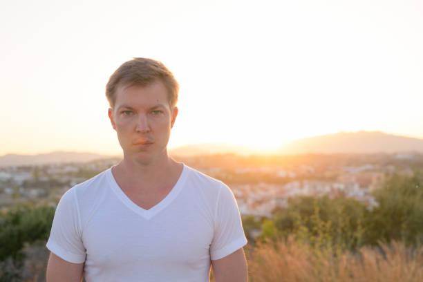 istock Young Handsome Tourist Man Looking At Camera Against Sunlight 1162255880