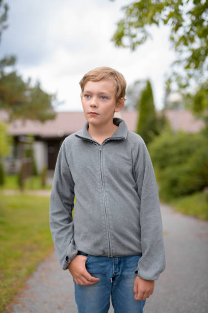 istock Young Blonde Handsome Boy Thinking While Standing At Home Outdoors 1162255994