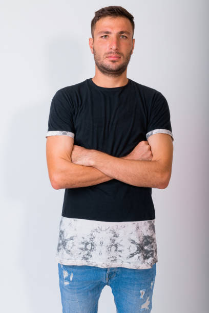 istock Handsome bearded Persian man with arms crossed against white background 1162256120
