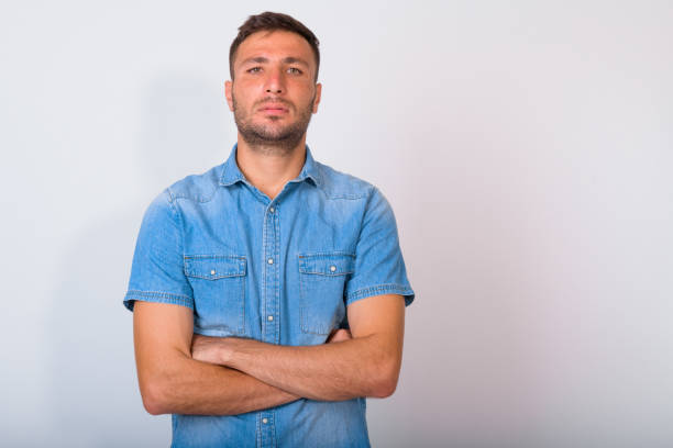 istock Handsome bearded Persian man with arms crossed against white background 1162256178
