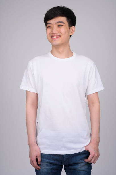 istock Studio shot of young happy Asian man smiling while thinking 1162256223