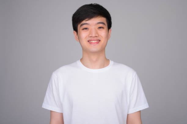 istock Studio shot of young happy Asian man smiling 1162256730