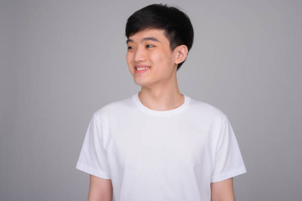 istock Studio shot of young happy Asian man smiling while thinking 1162256751