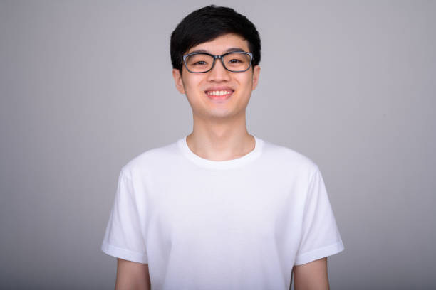 istock Studio shot of young happy Asian nerd man smiling while wearing eyeglasses 1162256816