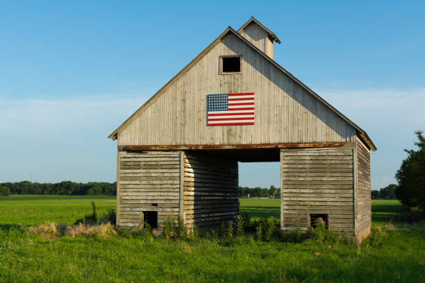 istock Old wooden barn with American Flag 1162257018